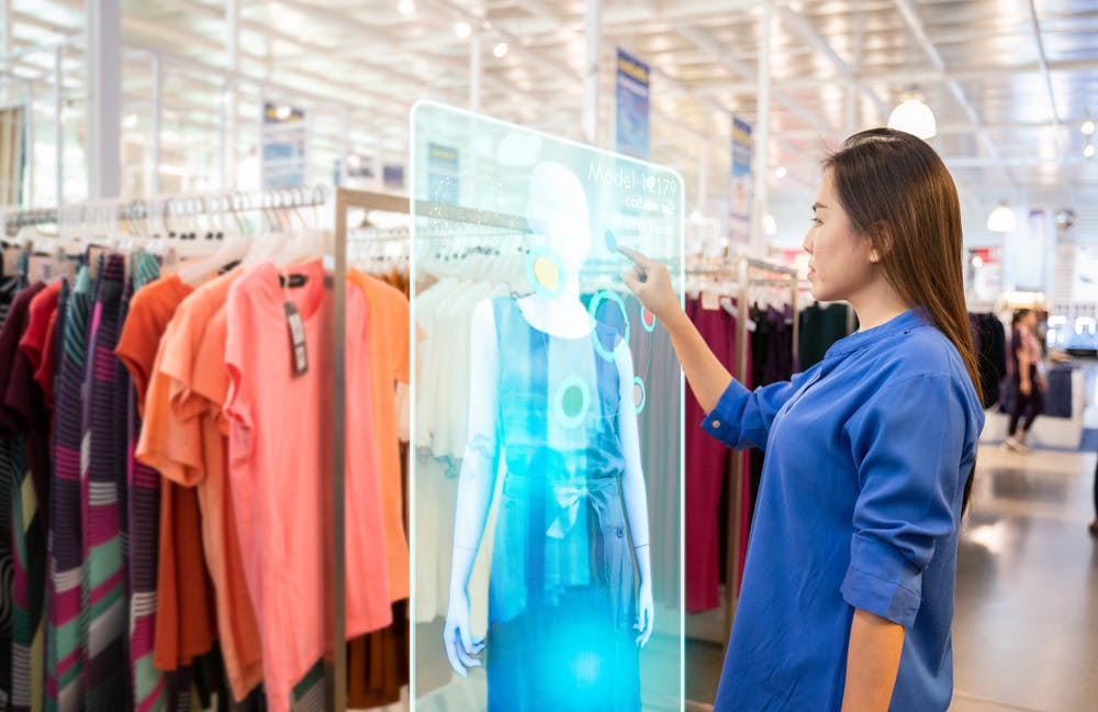 woman in clothing store using AI-powered augmented reality try-on