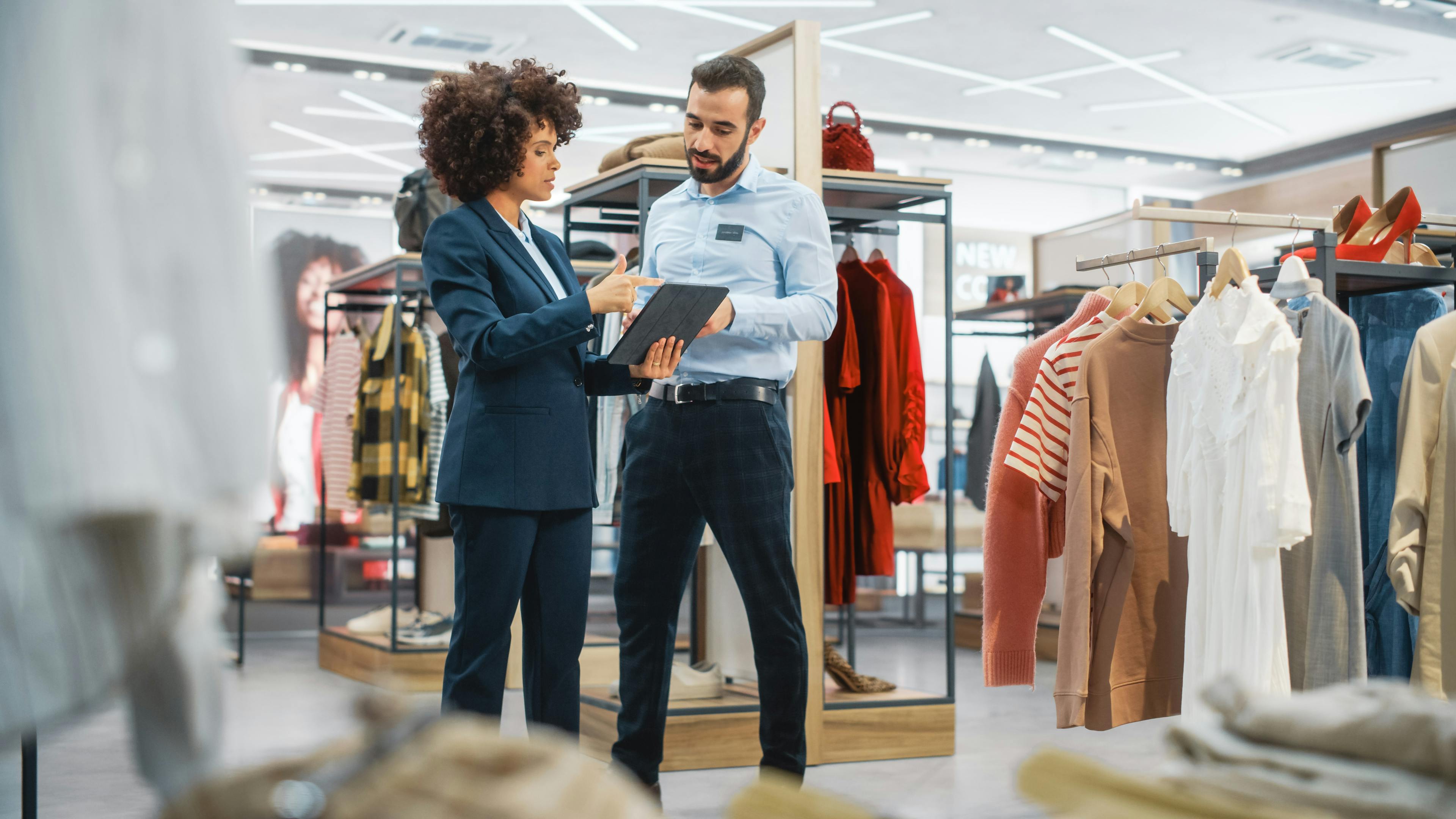 two store associates standing with a tablet in a department store