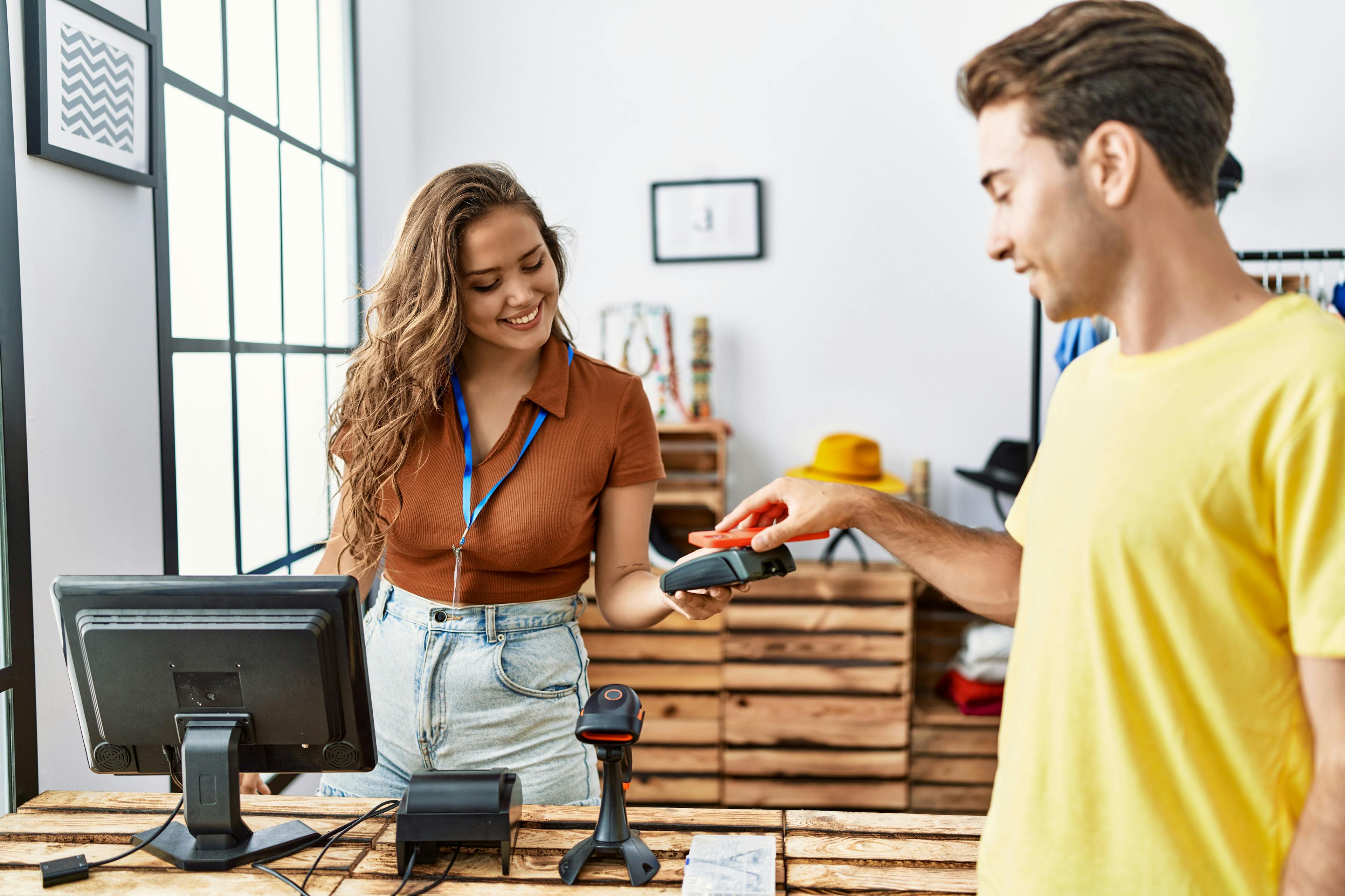 male shopper paying at female store associate