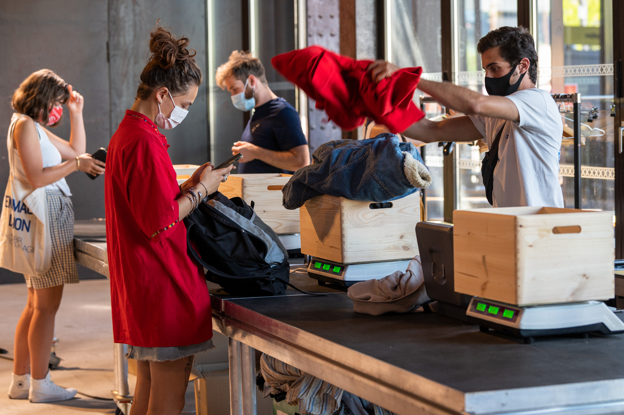 women recycling clothing at clothing recycling depot 